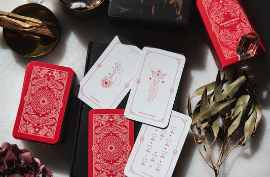 A table topped with lots of red and white playing cards